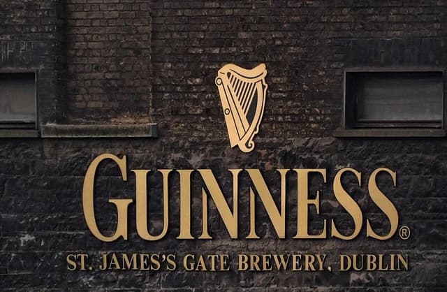 Guinness sign and harp logo on the wall of St. James's Gate Brewery in Dublin, Ireland.
