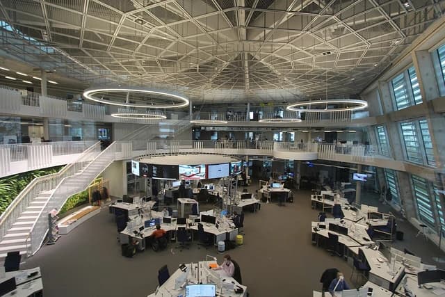 Wide-angle view of the ARD-aktuell newsroom with desks and monitors.