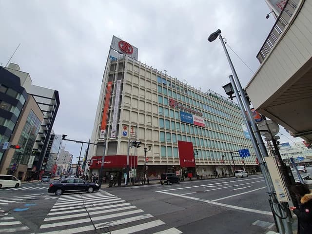Exterior view of the Takashimaya department store building in Omiya, Japan, from a street corner.
