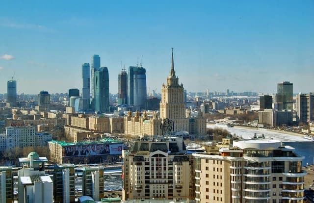 Aerial view of Moscow City skyline with skyscrapers and the frozen Moscow River.