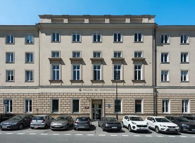 Building at Trębacka 4 in Warsaw, Poland, with parked cars on the street.