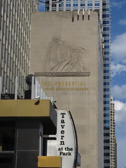 Exterior of One Prudential Plaza building in Chicago, Illinois, with signage.