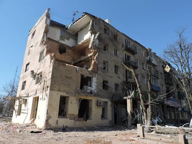 Heavily damaged apartment building with structural collapse in Kharkiv, Ukraine, following a Russian airstrike.