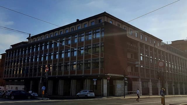 Dipartimento delle finanze building exterior with cars and pedestrian on a street in Rome.