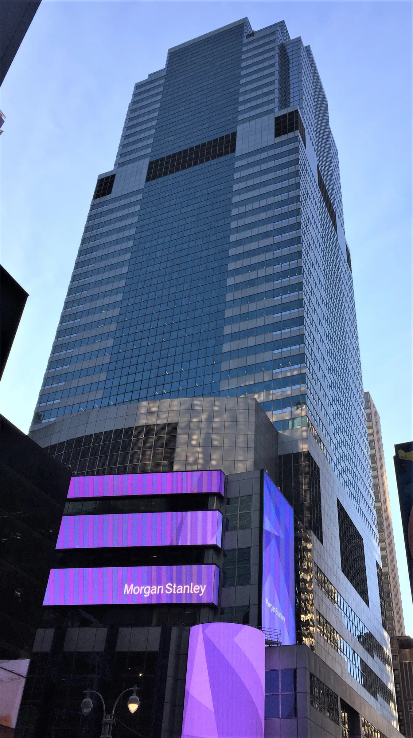 Morgan Stanley headquarters building with glowing purple screens in Times Square, New York City.