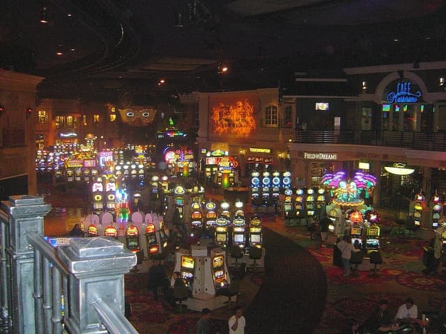 An expansive view of the Rio casino interior with slot machines and guests.