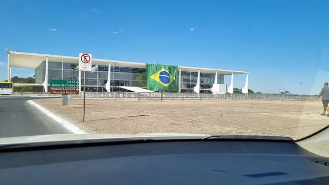 Brazilian flag displayed prominently on the facade of the Palácio do Planalto building.
