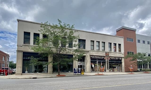 Exterior of the Bigelow Building in Buffalo, New York, featuring ground-floor shops and upper-level windows.
