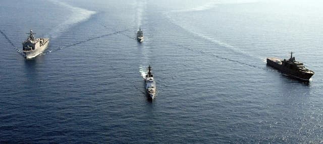 U.S. Navy and Republic of Singapore ships sailing in formation on the South China Sea.