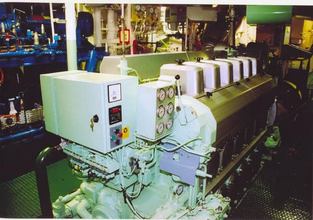 An engine room filled with complex machinery, gauges, and control panels.