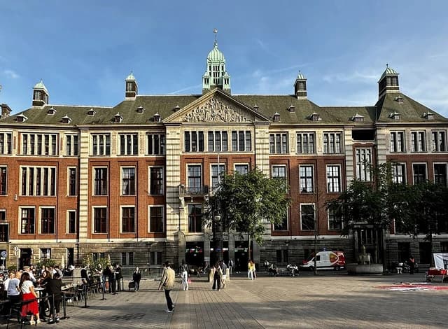 Euronext Amsterdam building, a historic stock exchange, stands under a clear sky.
