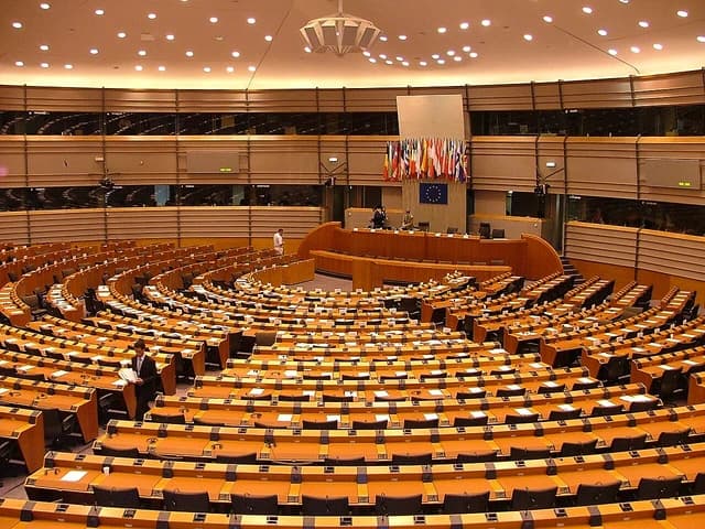 Interior view of the semicircular plenary chamber of the European Parliament.