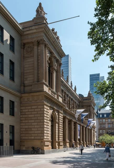 Frankfurt Stock Exchange building, a historic stone building, on a sunny day.