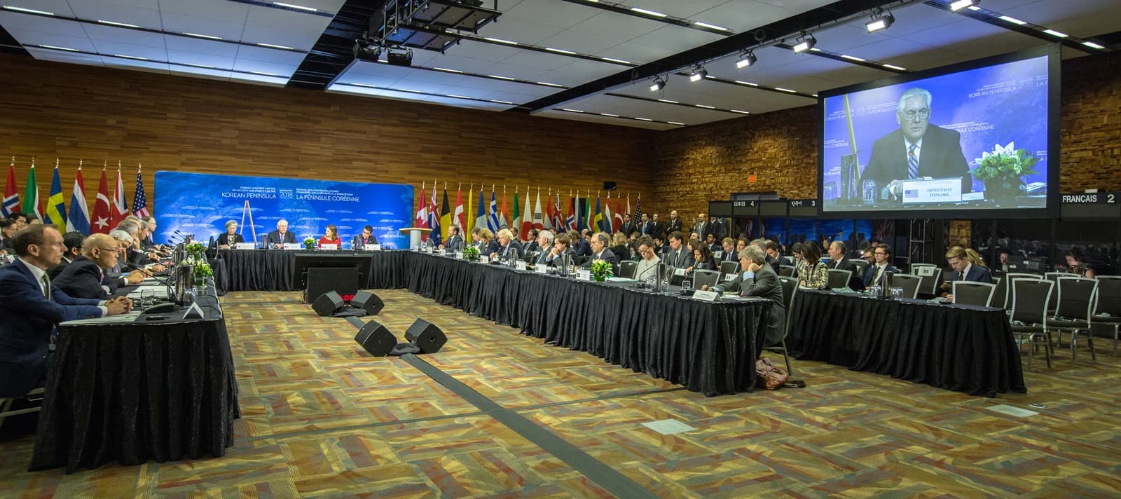 Delegates seated at a long conference table during the Korean Peninsula Summit.