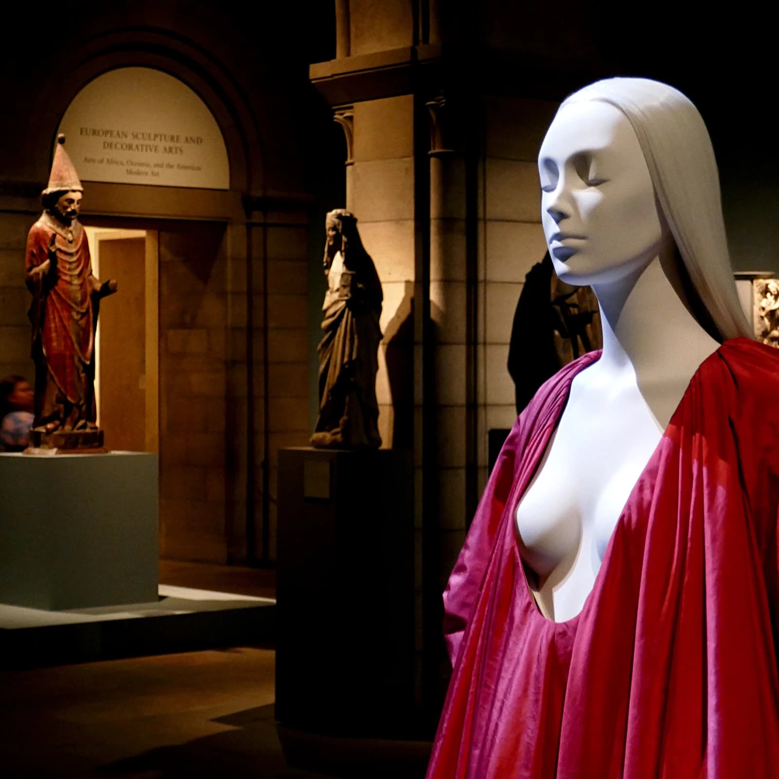 Mannequin wearing a long red Valentino evening dress at The Metropolitan Museum of Art.