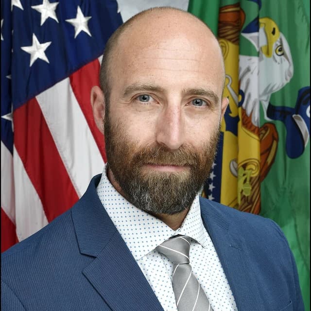Graham Steele, Assistant Secretary of the Treasury, looking directly at the camera.
