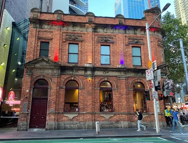 Bank of Australia building on Liverpool Street in Sydney, Australia, with pedestrians walking past.