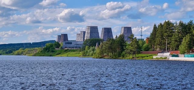 Bogoslovsky Aluminium Plant's cooling towers and industrial buildings across a wide river.