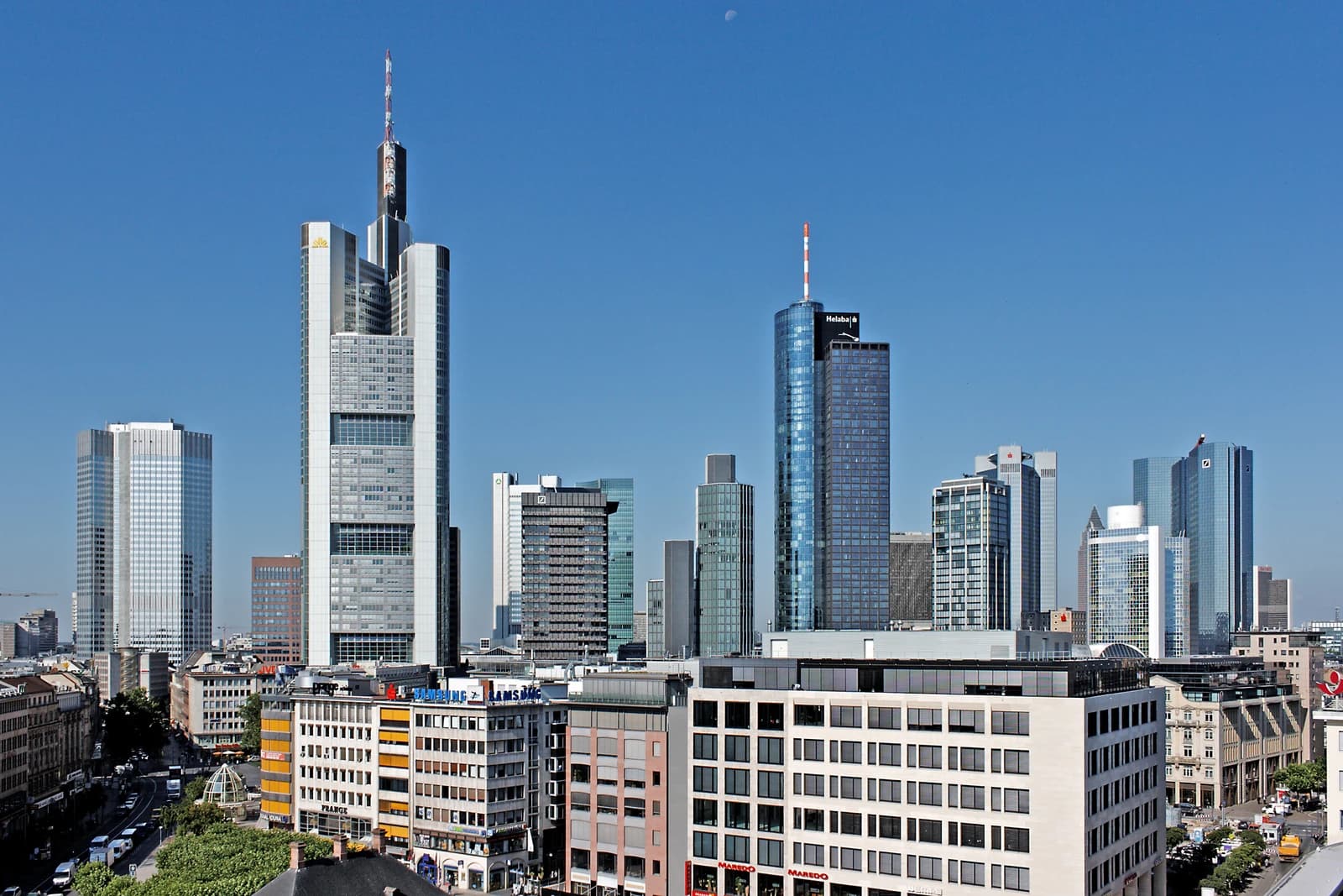 Skyline of Frankfurt's Bankenviertel, showcasing numerous high-rise bank buildings under a clear sky.