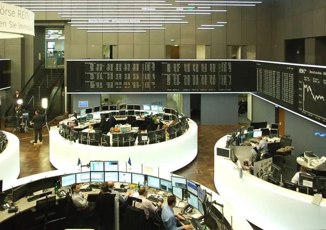 Traders monitor multiple screens on the trading floor of the Frankfurt Stock Exchange.