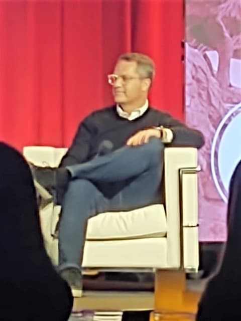 Doug McMillon, CEO of Walmart, seated on a stage at an event.