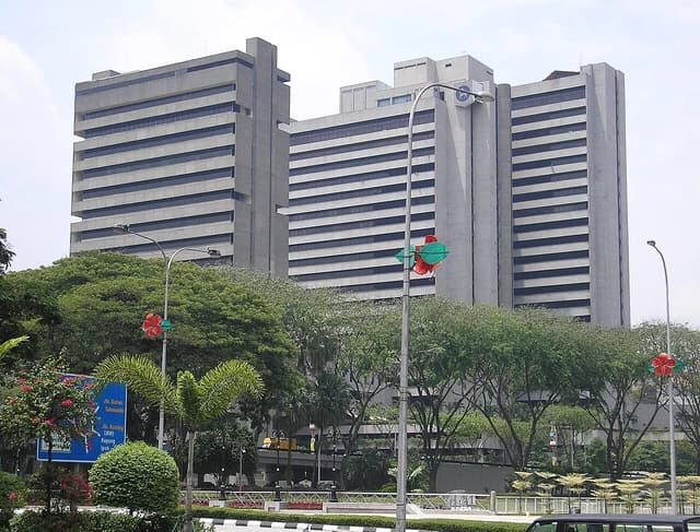 The gray concrete headquarters building of the Central Bank of Malaysia in Kuala Lumpur.