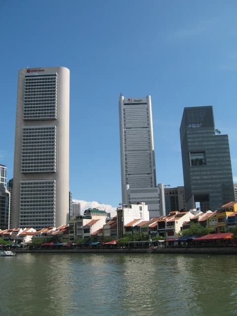 OCBC Centre building and other skyscrapers along a river in Singapore.