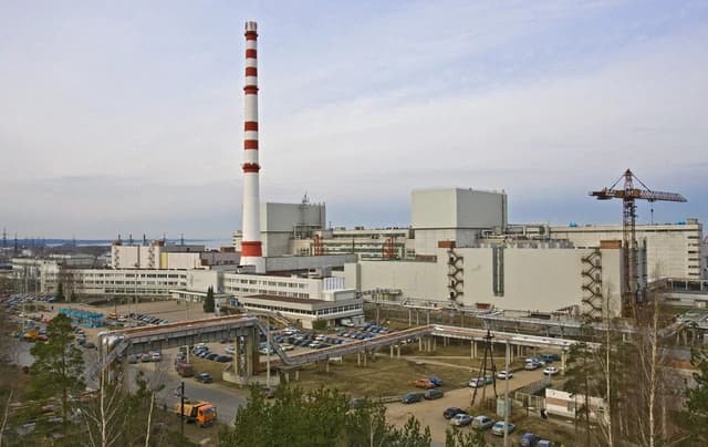 Aerial view of the Leningrad nuclear power plant with a prominent red and white striped chimney.