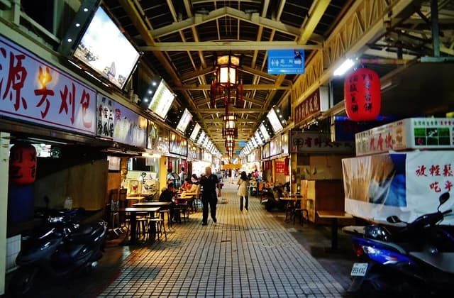 People walk and dine in a bustling night market in Taipei, Taiwan.