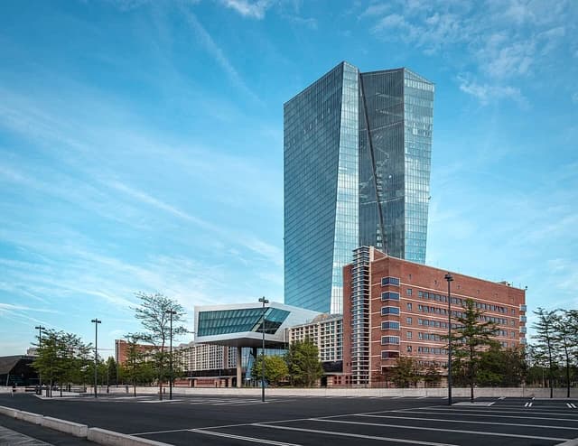 European Central Bank headquarters buildings in Frankfurt, Germany under a blue sky.