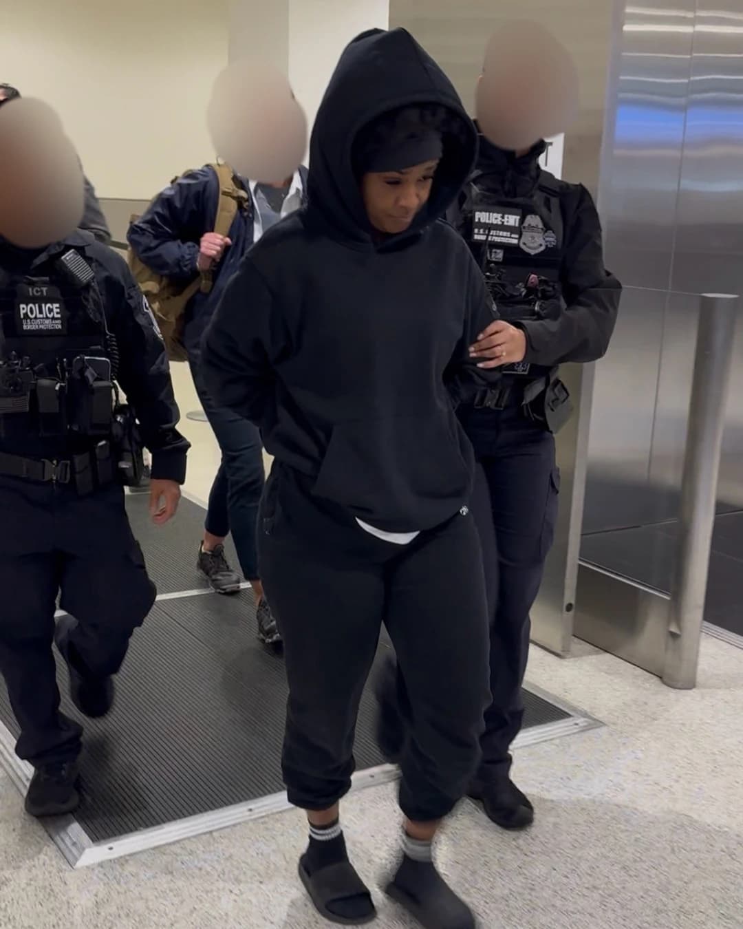 Elaine Angene Escoe, Most Wanted Fraudster, is escorted by FBI Special Agents.