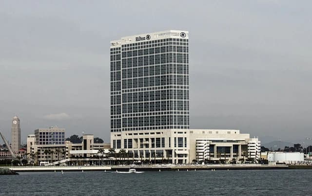 Hilton San Diego Bayfront Hotel, a modern high-rise building, viewed from the water.