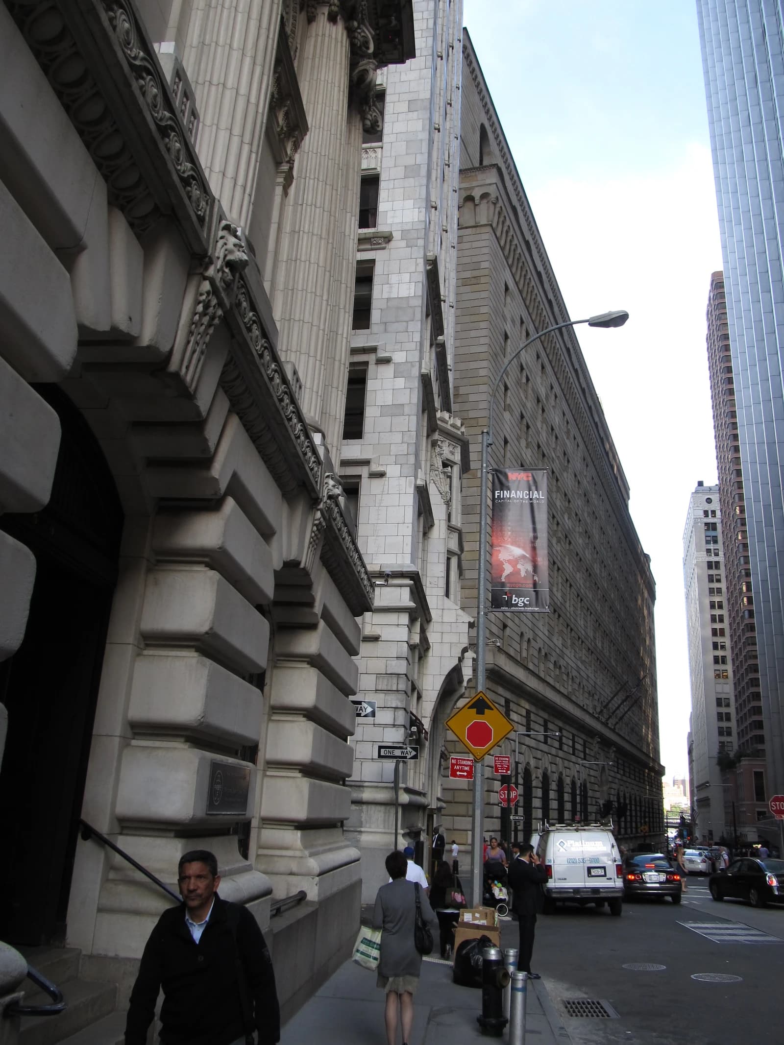 Pedestrians walk past the Federal Reserve Bank of New York building on Liberty Street.