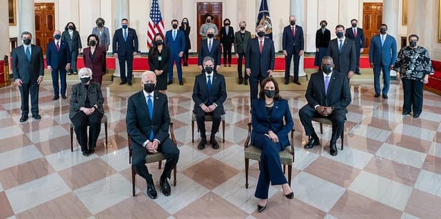 President Joe Biden, Vice President Kamala Harris, and cabinet members posing for a group photo.