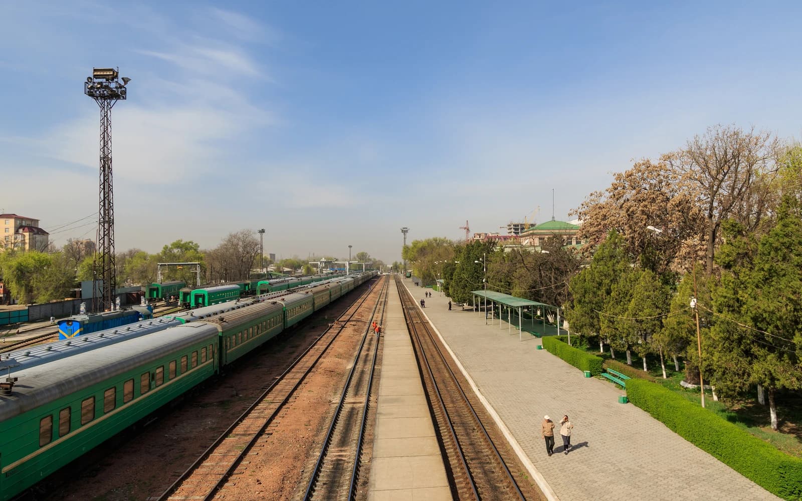 Bishkek-2 railway station showing trains parked on tracks and a platform.