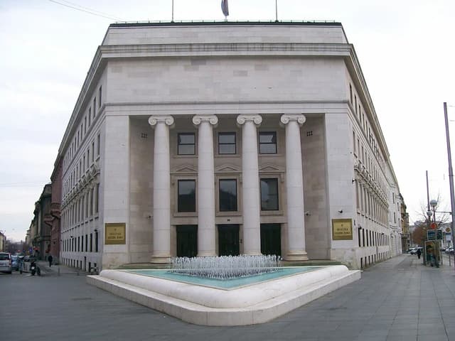 Croatian National Bank headquarters building, a large stone structure with columns and a fountain.