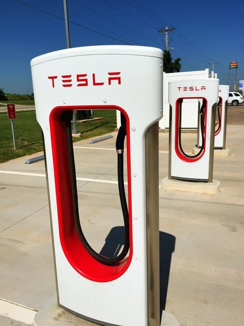 Tesla electric car charging stations in Perry, Oklahoma on a sunny day.
