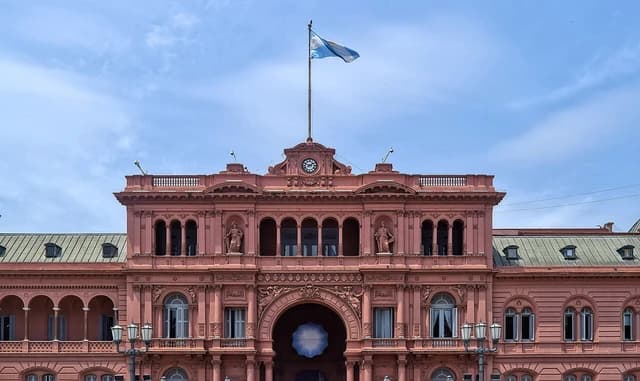 Casa Rosada, the pink presidential palace in Buenos Aires, under a blue sky.