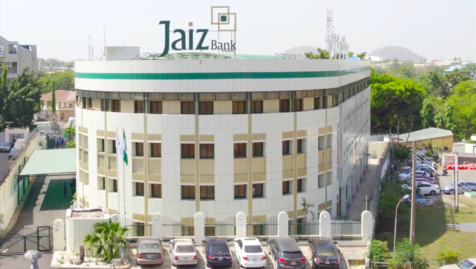New Jaiz Bank Head Office building with cars parked outside.
