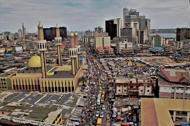 Aerial view of Lagos Island, Nigeria, featuring a large mosque and bustling street.