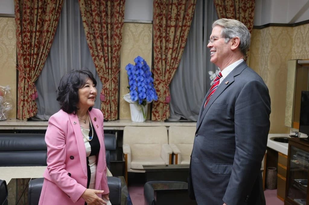 U.S. Treasury Secretary Scott Bessent standing and talking with Japanese Finance Minister Satsuki Katayama.