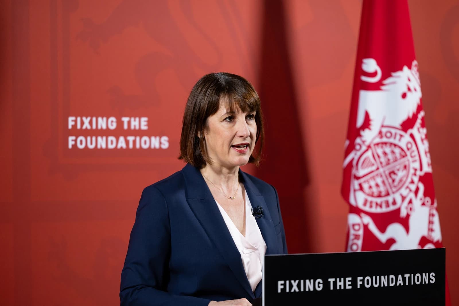 Rachel Reeves, UK Shadow Chancellor of the Exchequer, delivering a speech at a podium.