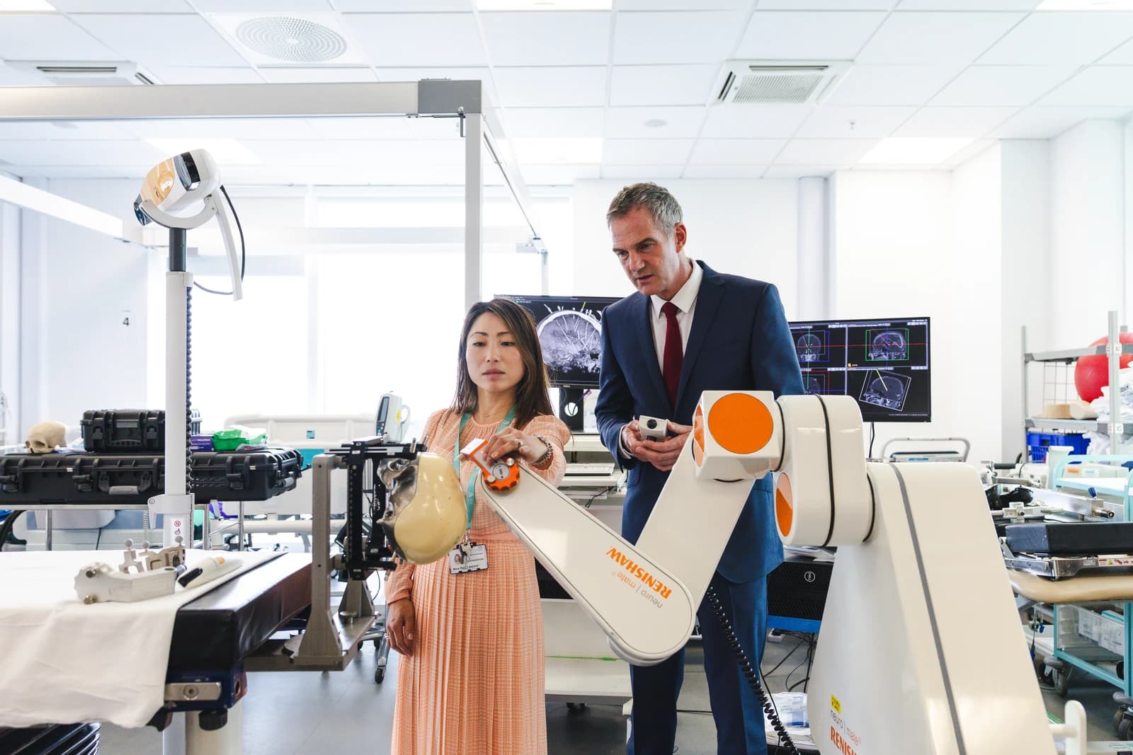 Peter Kyle and a woman demonstrating medical robotic equipment at Southmead Hospital.