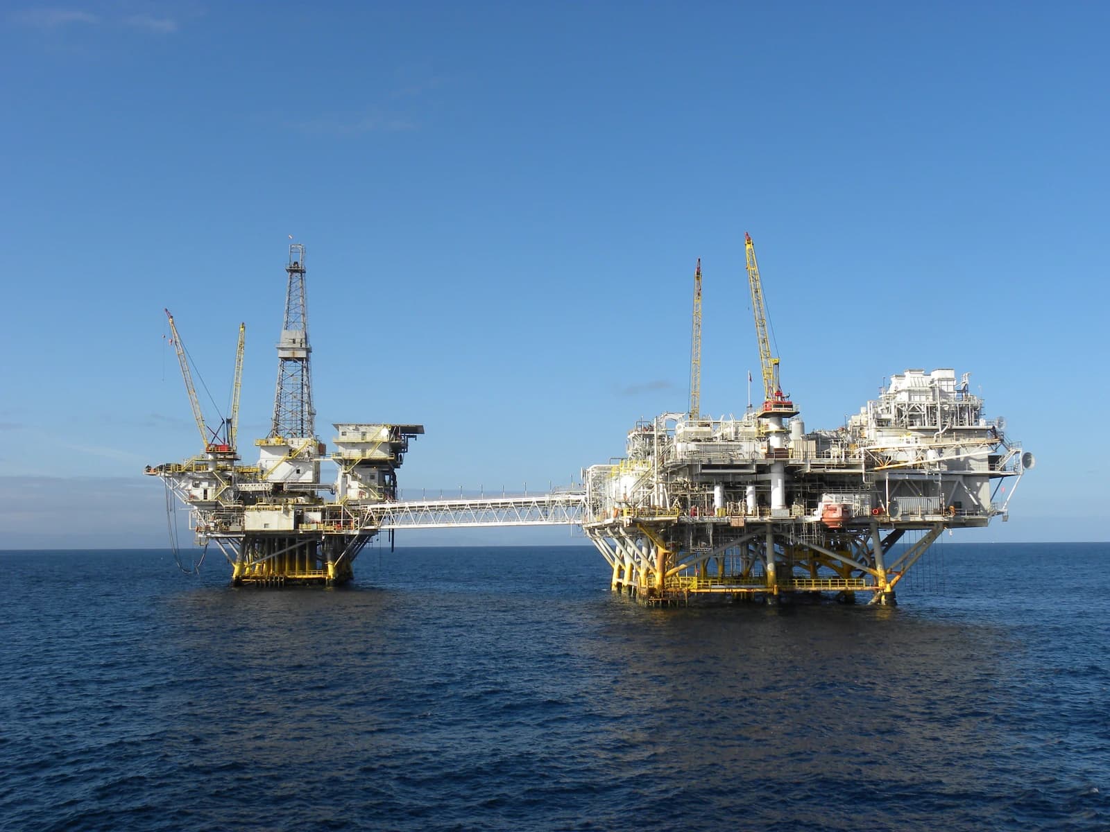 Two offshore oil platforms, Ellen and Elly, connected by a walkway in the ocean.