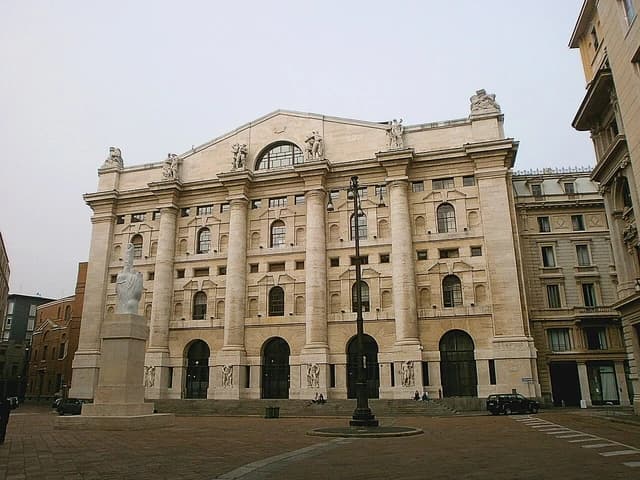 Palazzo Mezzanotte, a large stone building with columns, in Piazza Affari, Milan.