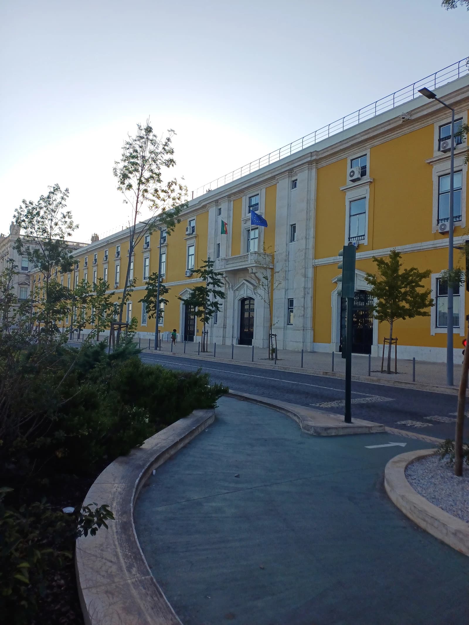 Exterior view of the bright yellow Portuguese Ministry of Finance building in Lisbon.