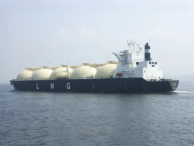 The LNG carrier Shahamah sails on calm waters under a clear sky.