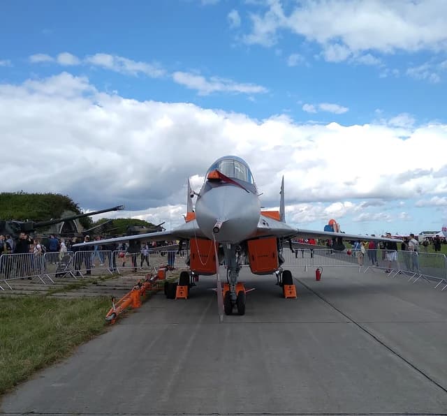 Polish Air Force MiG-29 fighter jet on an airfield with spectators in the background.