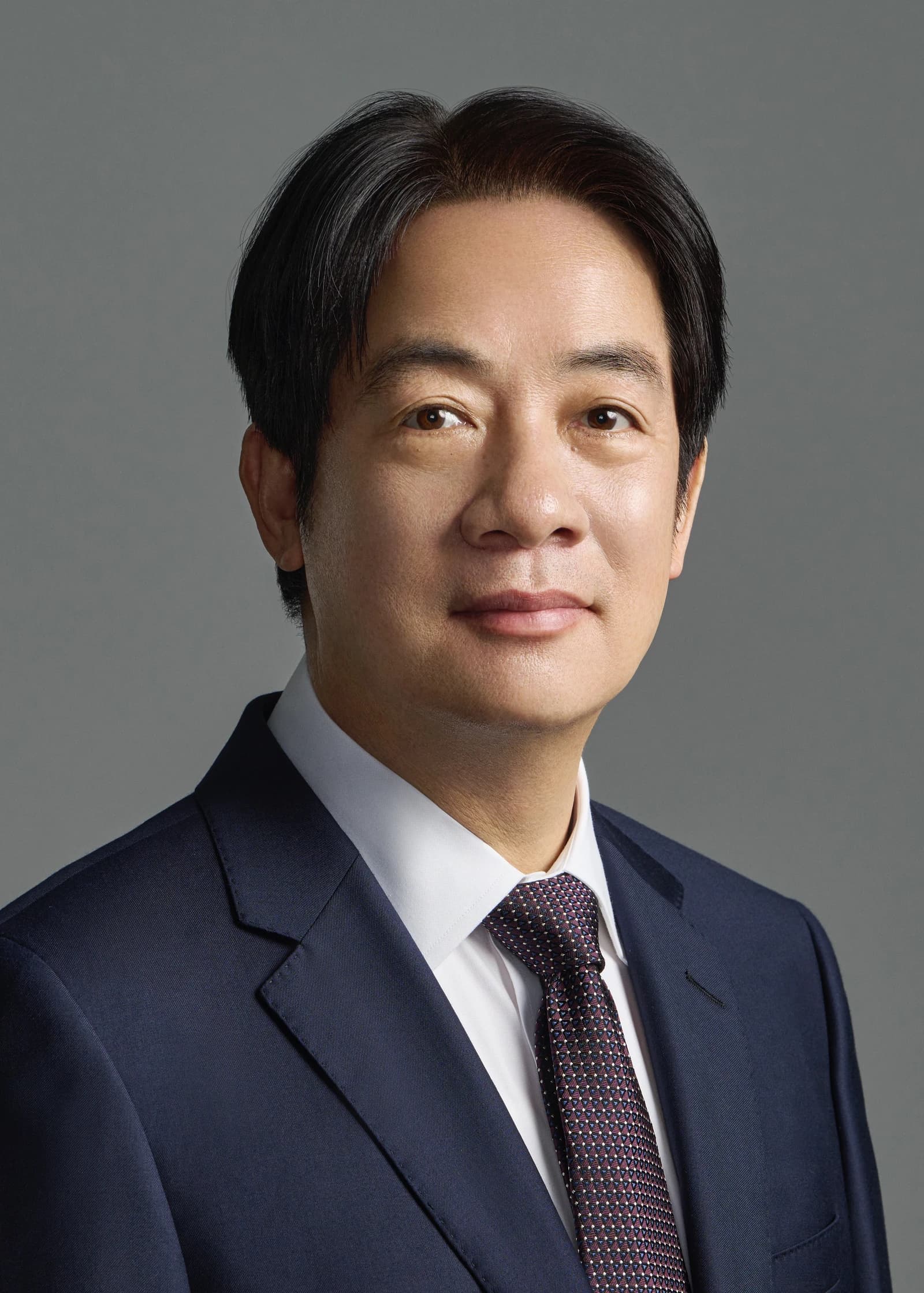 Lai Ching-te, Taiwan's President, in a suit and tie, looking at the camera.