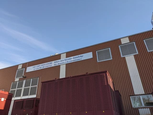 Exterior of the CERN Data Centre building, brown corrugated metal, blue sky.